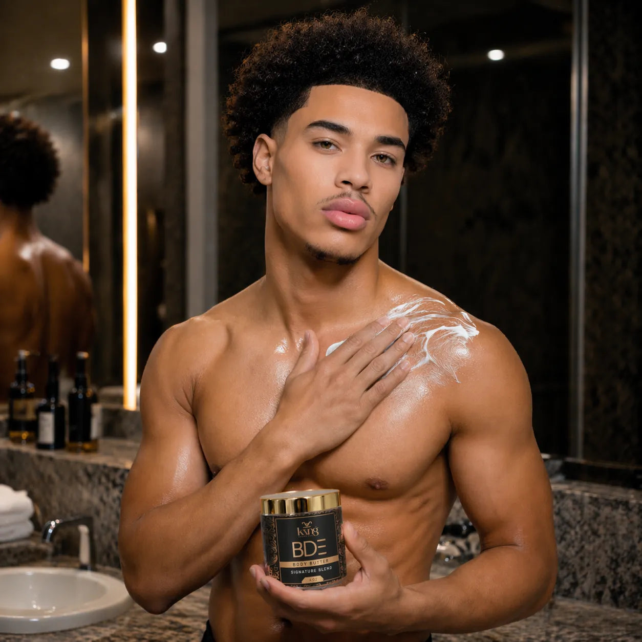 Man applying cream to his shoulder in a bathroom setting, holding a jar of BDE cream.